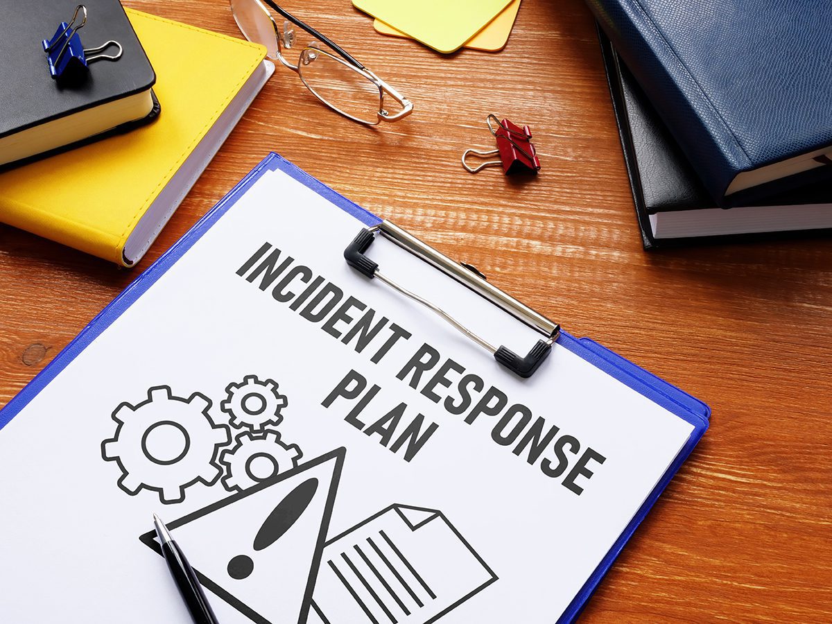 A clipboard holding a page with the words “incident response” printed on it